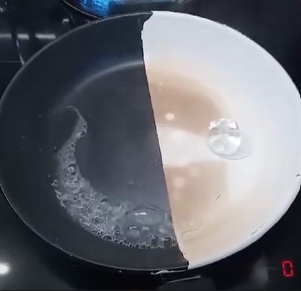 Picture of thermacote covering half of a hot frying pan, showing a melted ice cube on the uncoated side, and a whole icecube on the coated side